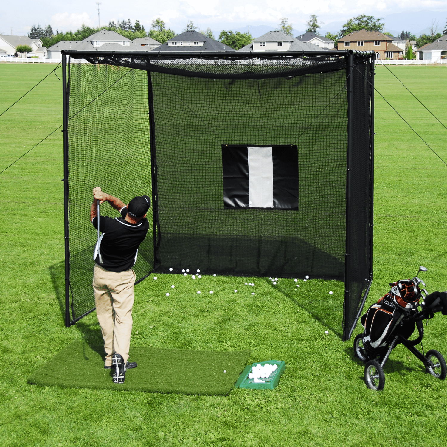 golfer hitting golf balls into custom golf cage