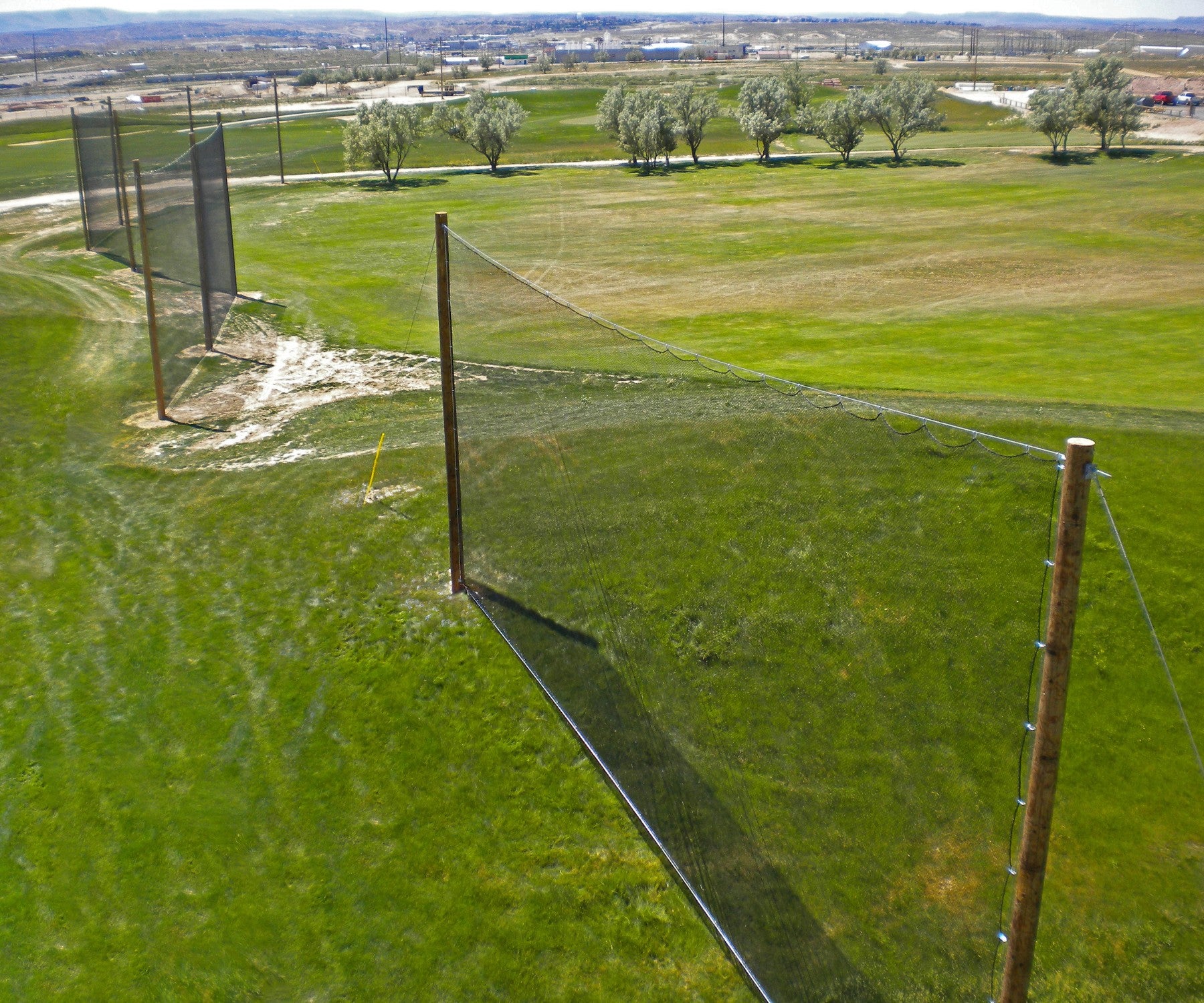Custom golf driving range netting for golf course from helicopter view