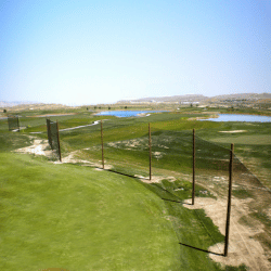 Custom golf driving range netting for golf course from helicopter view