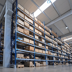 Shelving with many boxes in a warehouse.